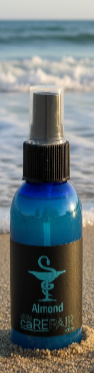 Blue spray bottle labeled 'Almond Skin Care Repair' with a black cap.